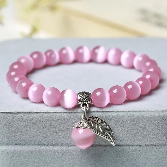 Armband kattenoog kralen roze met bedel blad